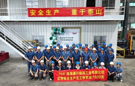 SKD employees wearing hard hats and holding a banner