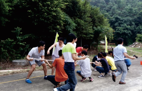 SKD employees doing a group activity along the roadside